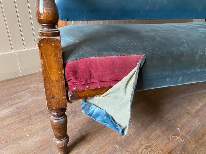 An image of a fabric tearing away on a run down old fashioned bench